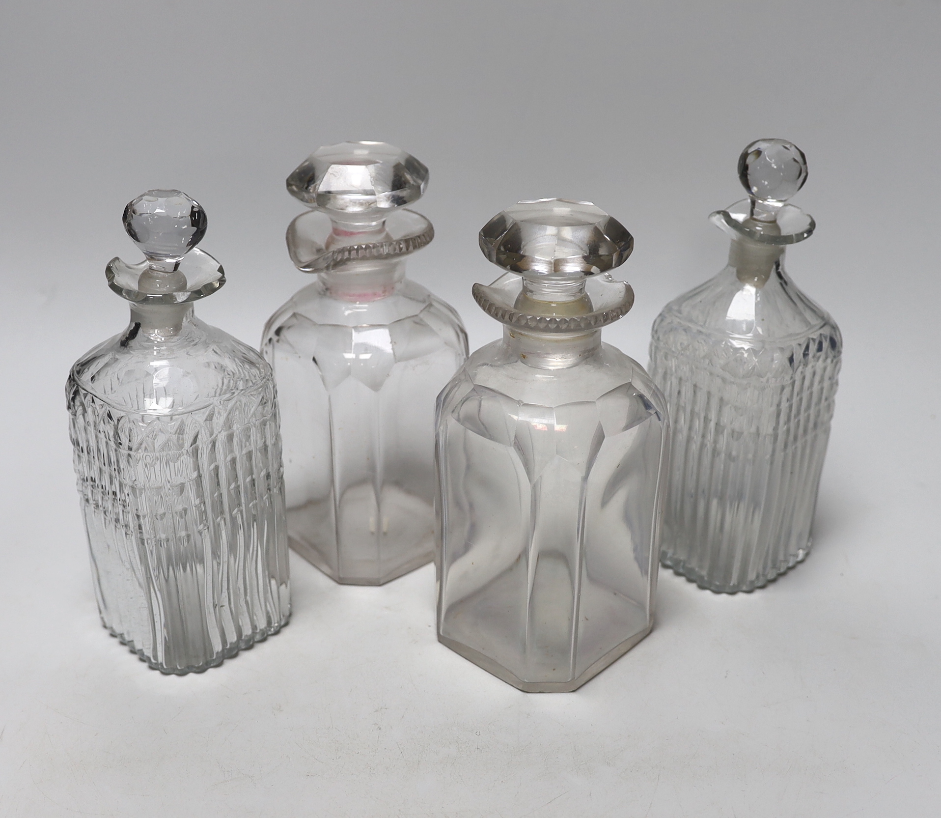 Two pairs of Georgian moulded and cut glass square decanters, all with lips, stoppers and ground pontils, highest 20cm (4)
